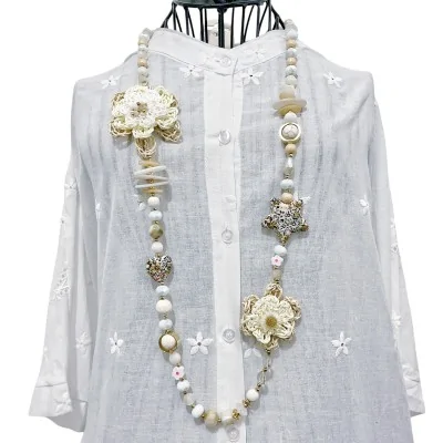 Collana lunga bohémien con fiore in rafia e ciondoli Liberty