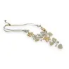 Collier fantaisie avec fleurs et cœurs dorés et ivoires sur cordon blanc