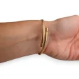 Brazalete de encantos rígido dorado y negro estrella