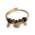Bracelet charms rigide noir et doré cœur strass