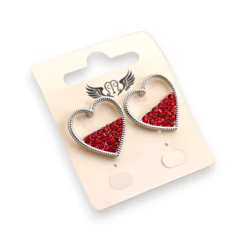 Silver heart-shaped earrings with red rhinestones