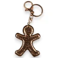 Gold keychain shaped like a biscuit man