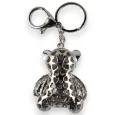 Silver teddy bear keychain with brown striped shirt