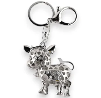 Silver cow keychain with its daisy