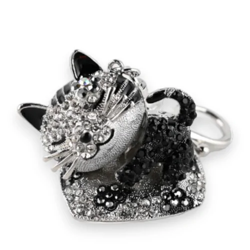 Silver Cat Keychain on its Cushion