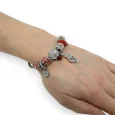 Silver and red rigid charms bracelet with treble clef