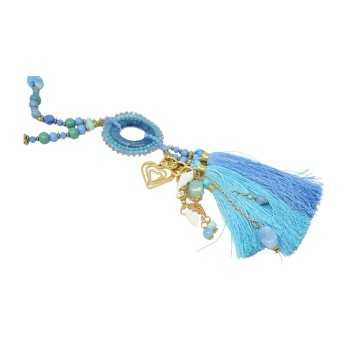 Long fantasy necklace in shades of blue with round medallion, tassel and charms