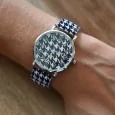 Ernest's watch has a black and white houndstooth pattern