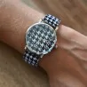 Ernest\'s watch has a black and white houndstooth pattern