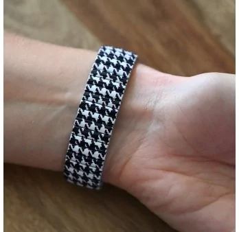 Ernest's watch has a black and white houndstooth pattern