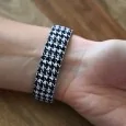 Ernest's watch has a black and white houndstooth pattern