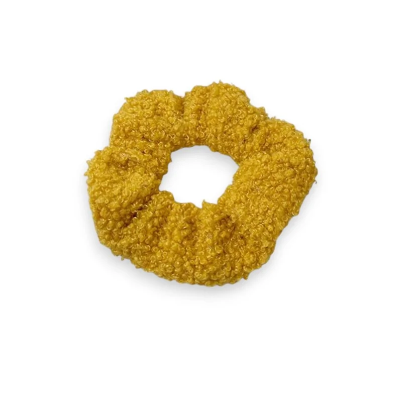 Mustard-colored scrunchie with curly texture