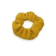 Mustard-colored scrunchie with curly texture