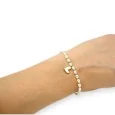 Fine elastic bracelet with white and gold beads