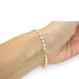 Fine elastic bracelet with white and gold beads