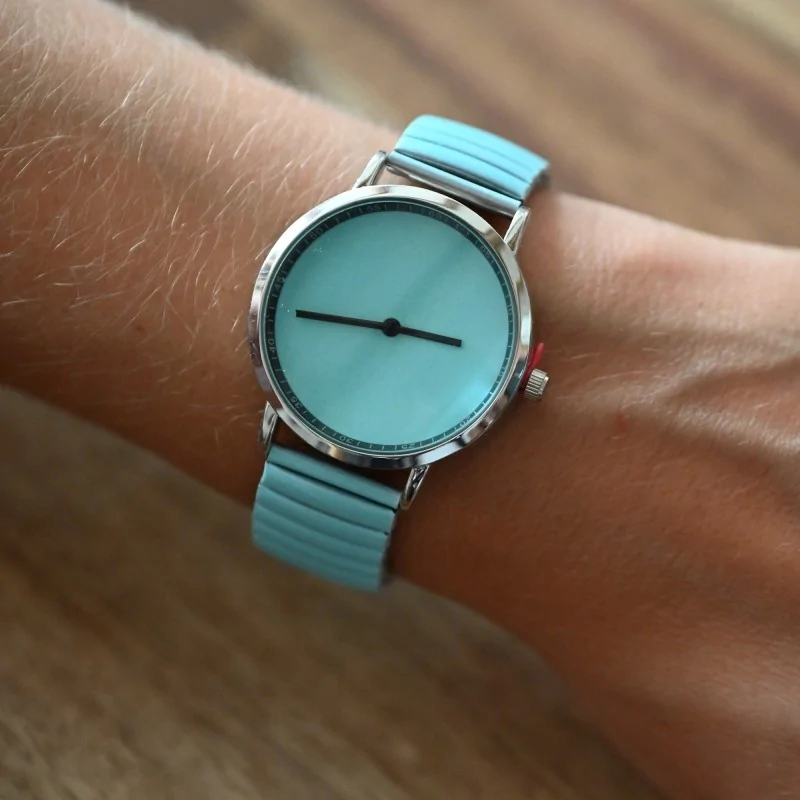 Ernest is wearing a solid turquoise watch