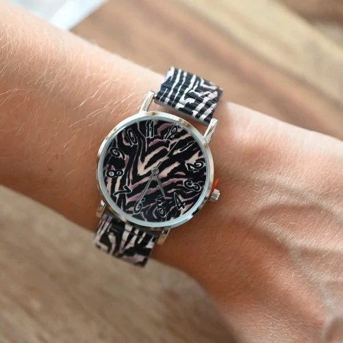 Ernest's watch is printed with black and beige animal pattern