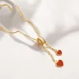 Collana in acciaio dorato con doppio ciondolo a cuore rosso