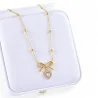 Butterfly knot heart necklace Gold plated steel