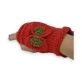 Red knitted mittens with golden knot