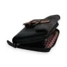 Portefeuille compact noir en cuir avec fermeture éclair et détail marron, vue rapproc...